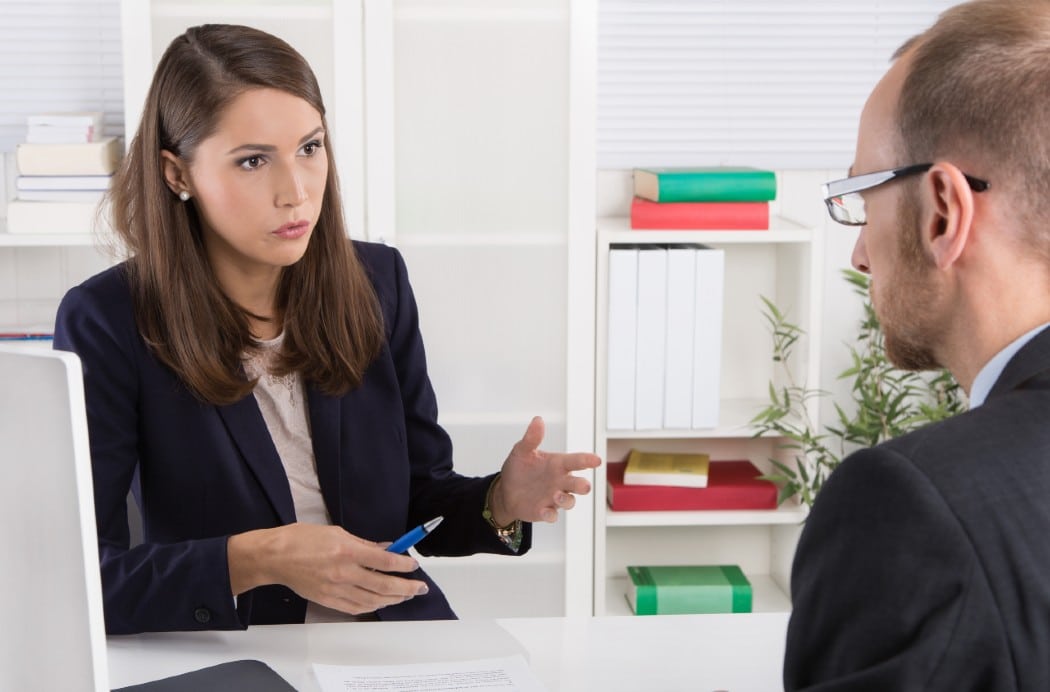 woman in office communicating with man