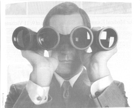 Man looking through binoculars with two extra lenses so he can find strategic opportunities