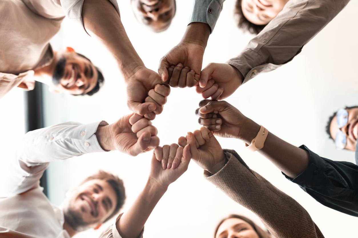 Portrait of diverse business people giving fist bump in circle stock photo