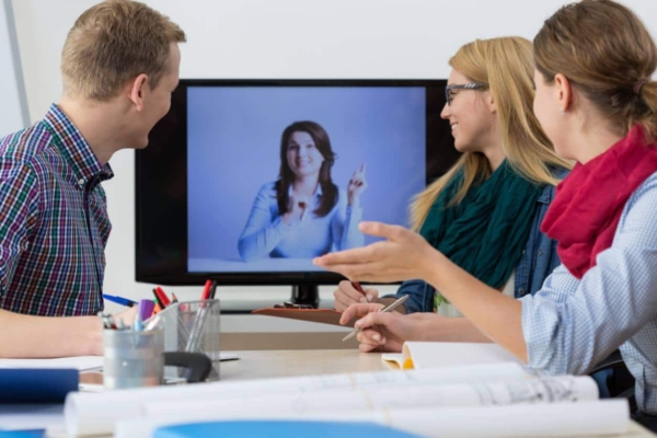 woman on video call with coworkers in office