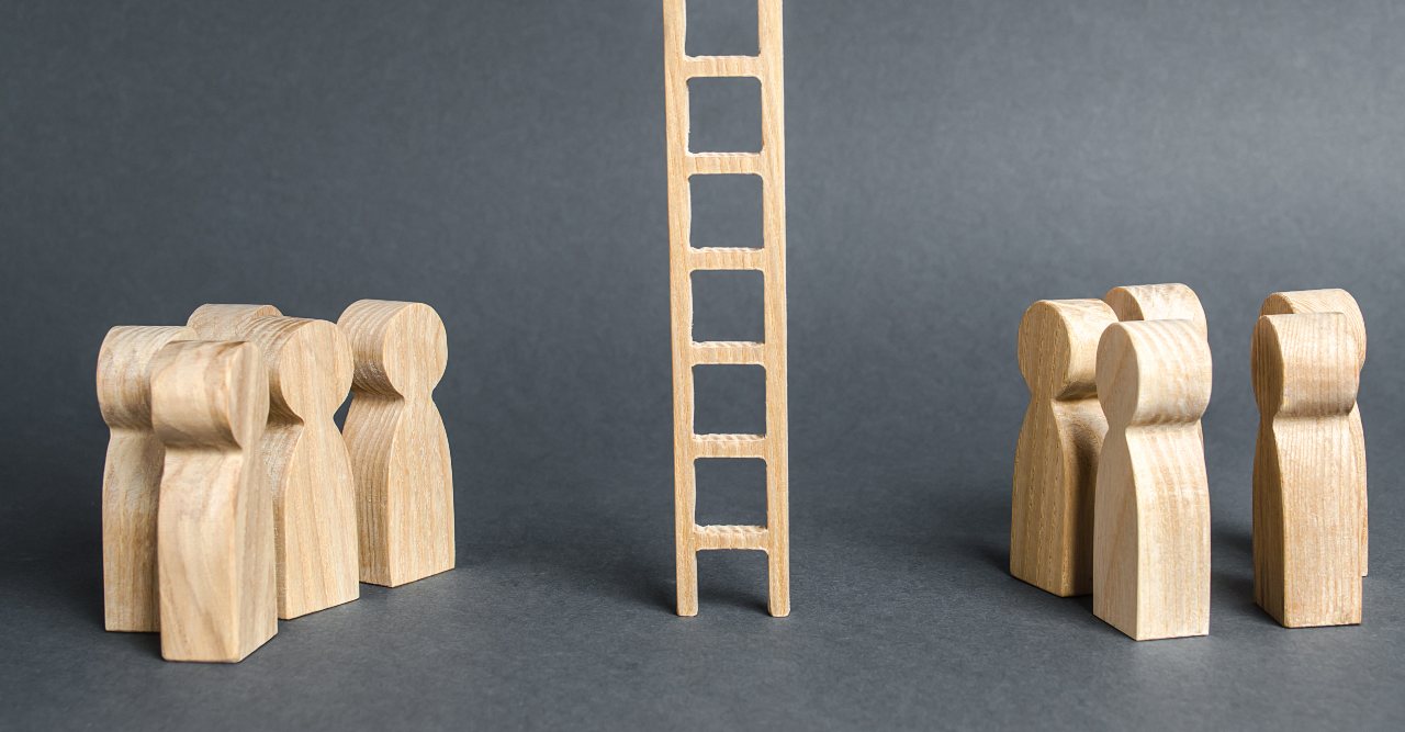 wooden figures standing on either side of a ladder