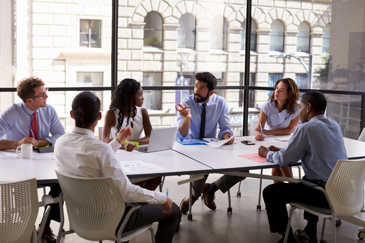 Manager and employees talking at conference table