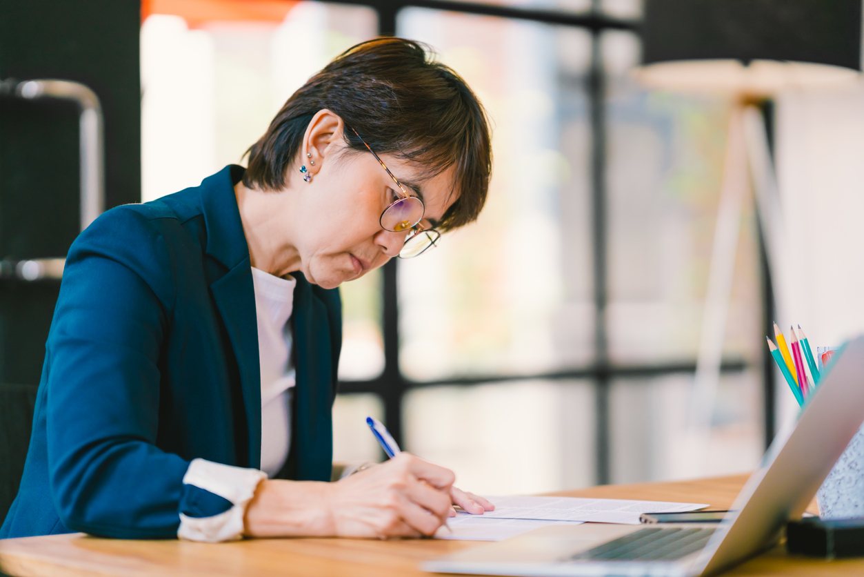 woman working on paperwork in modern contemporary office