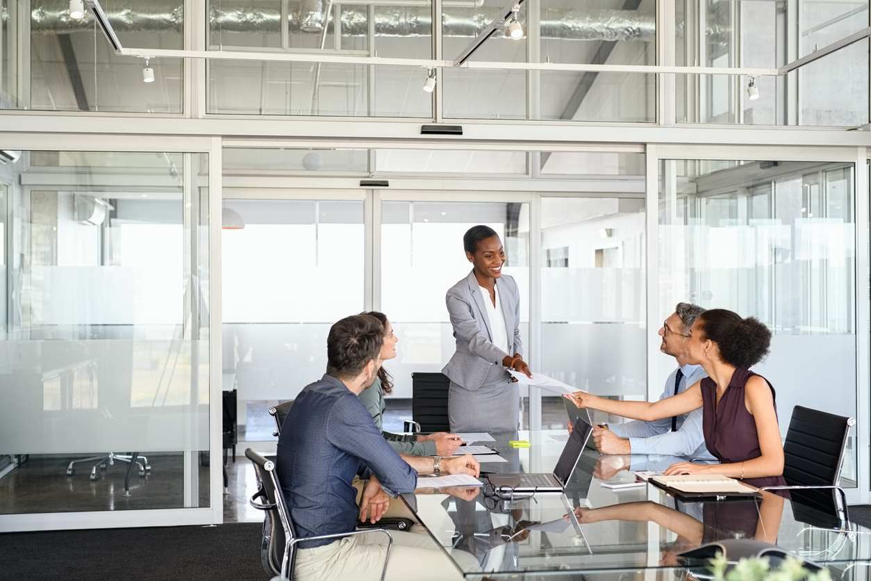 Smiling business people sharing document