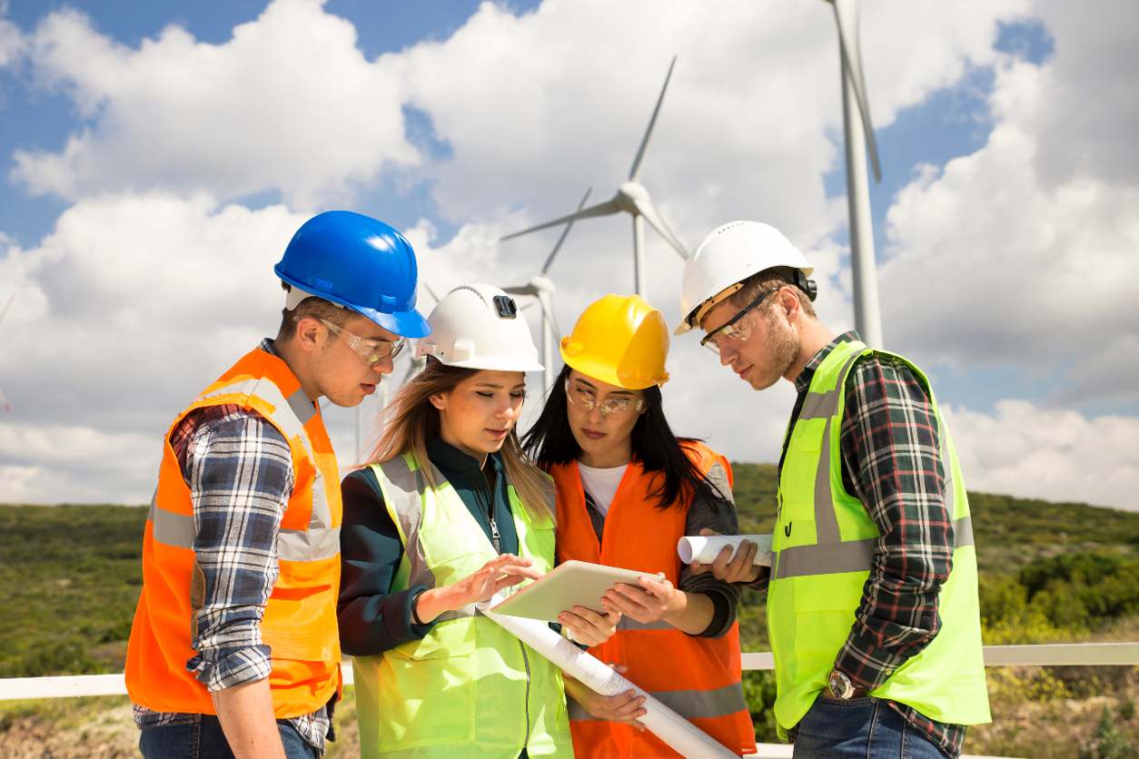 construction team in front of windmills