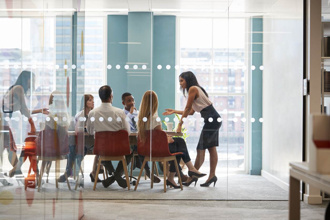 team gathered around table in an office