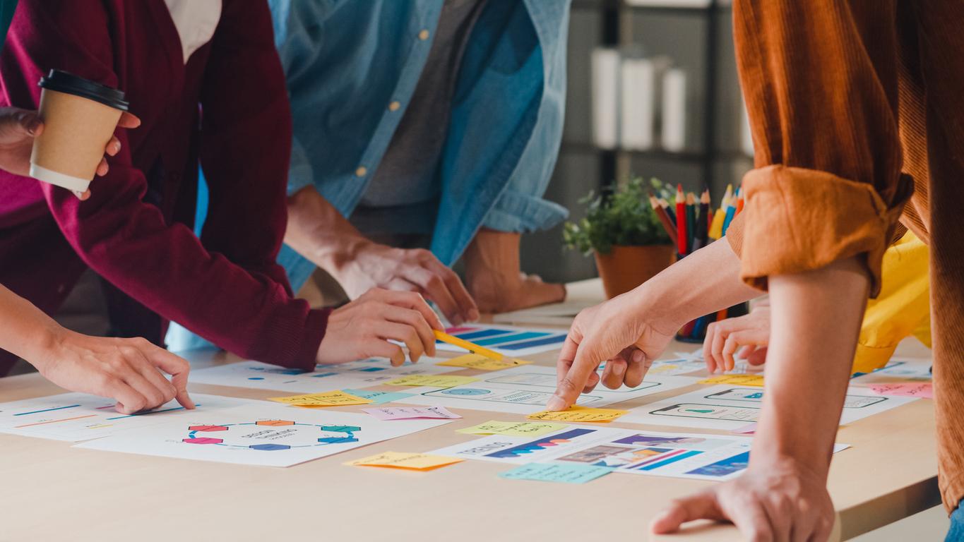 close up of people looking at printed charts and graphs on a table