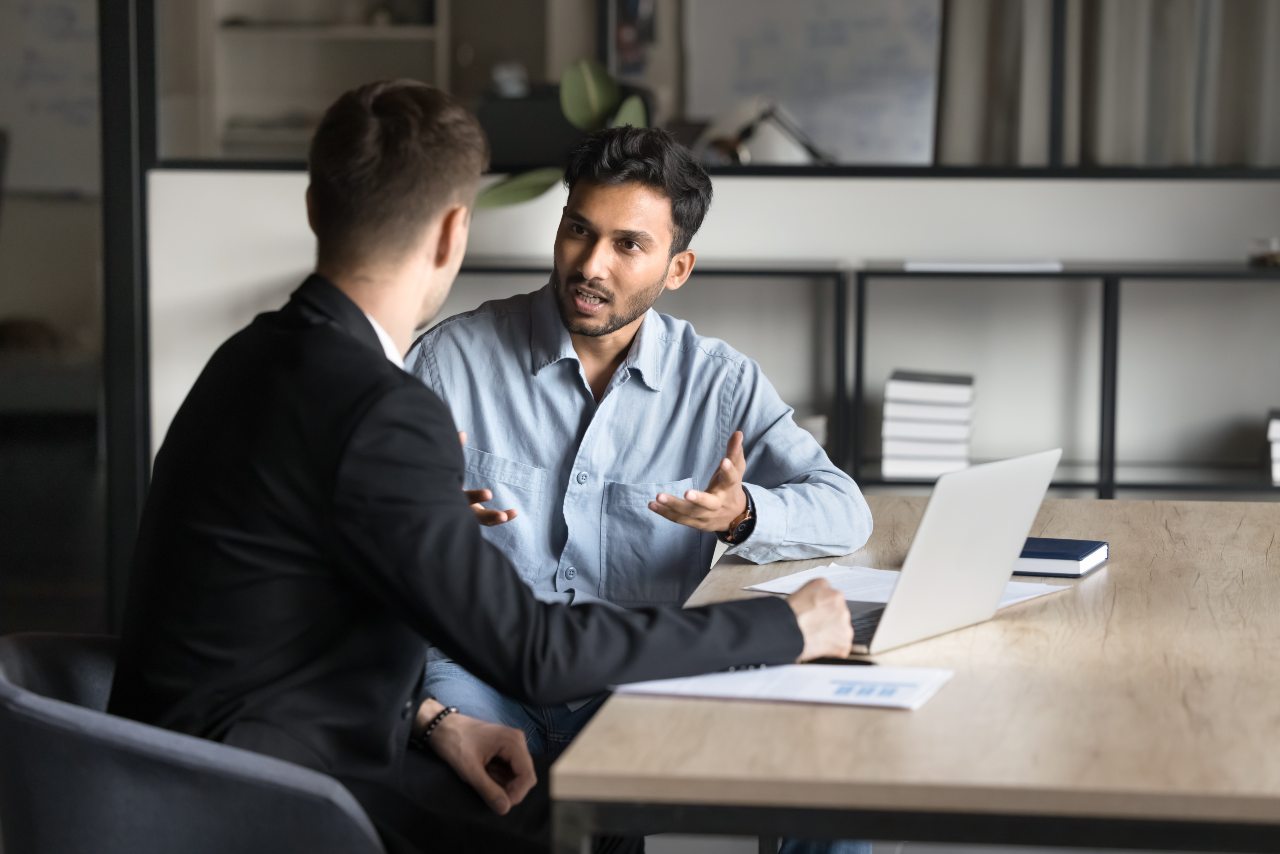 hero image - two males meeting;one speaking