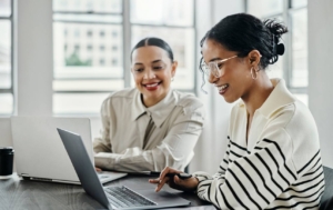 two employees looking at laptop