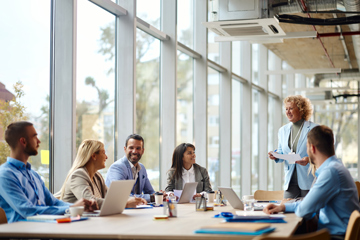 female businesswoman leading meeting in an office setting