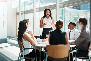 female leading training meeting in office setting