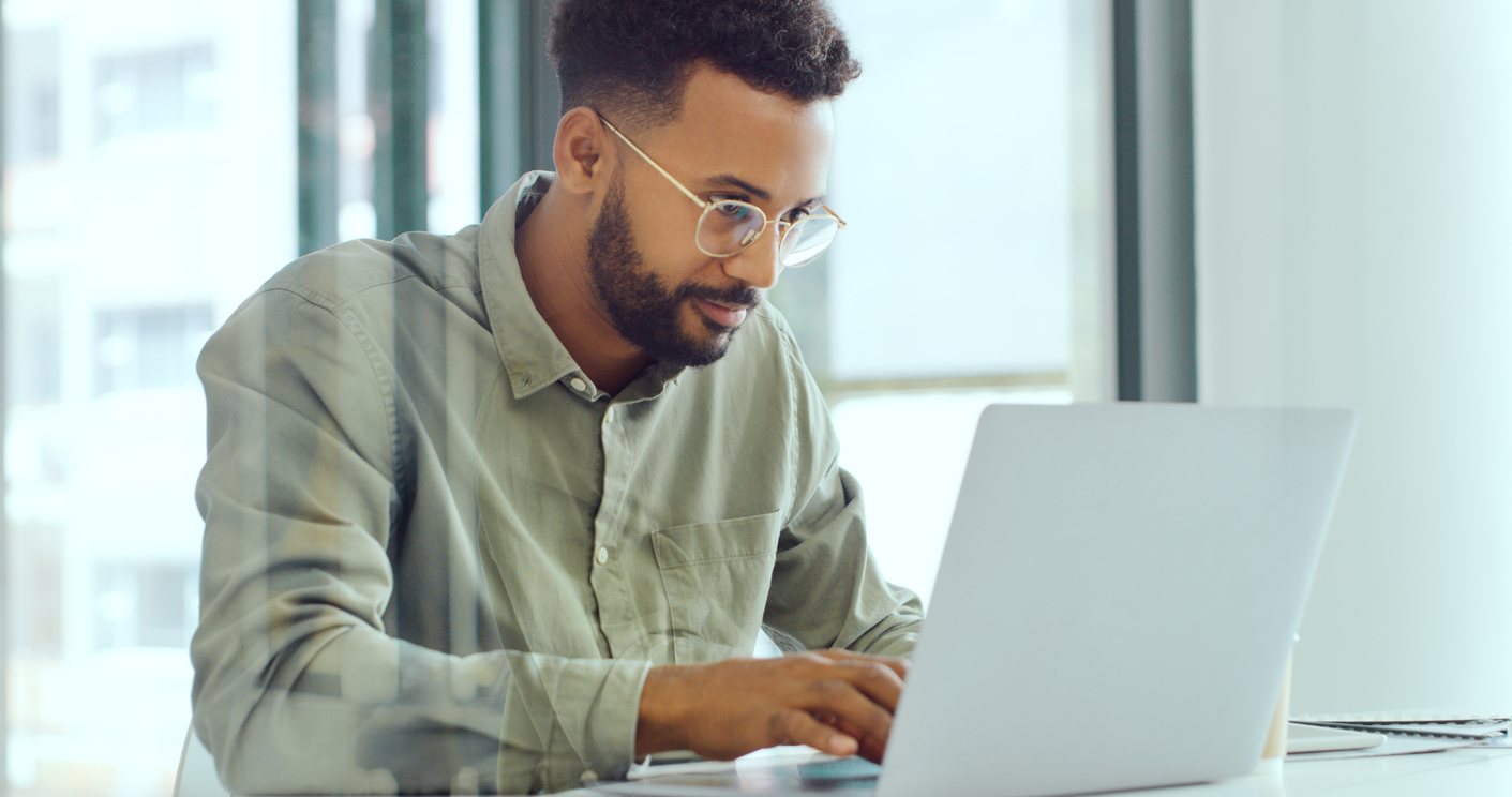 man typing on laptop in office